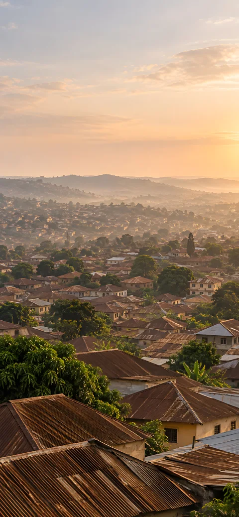 Copper rooftops, soft haze and a city waking slowly. AI-assisted Ibadan artwork.