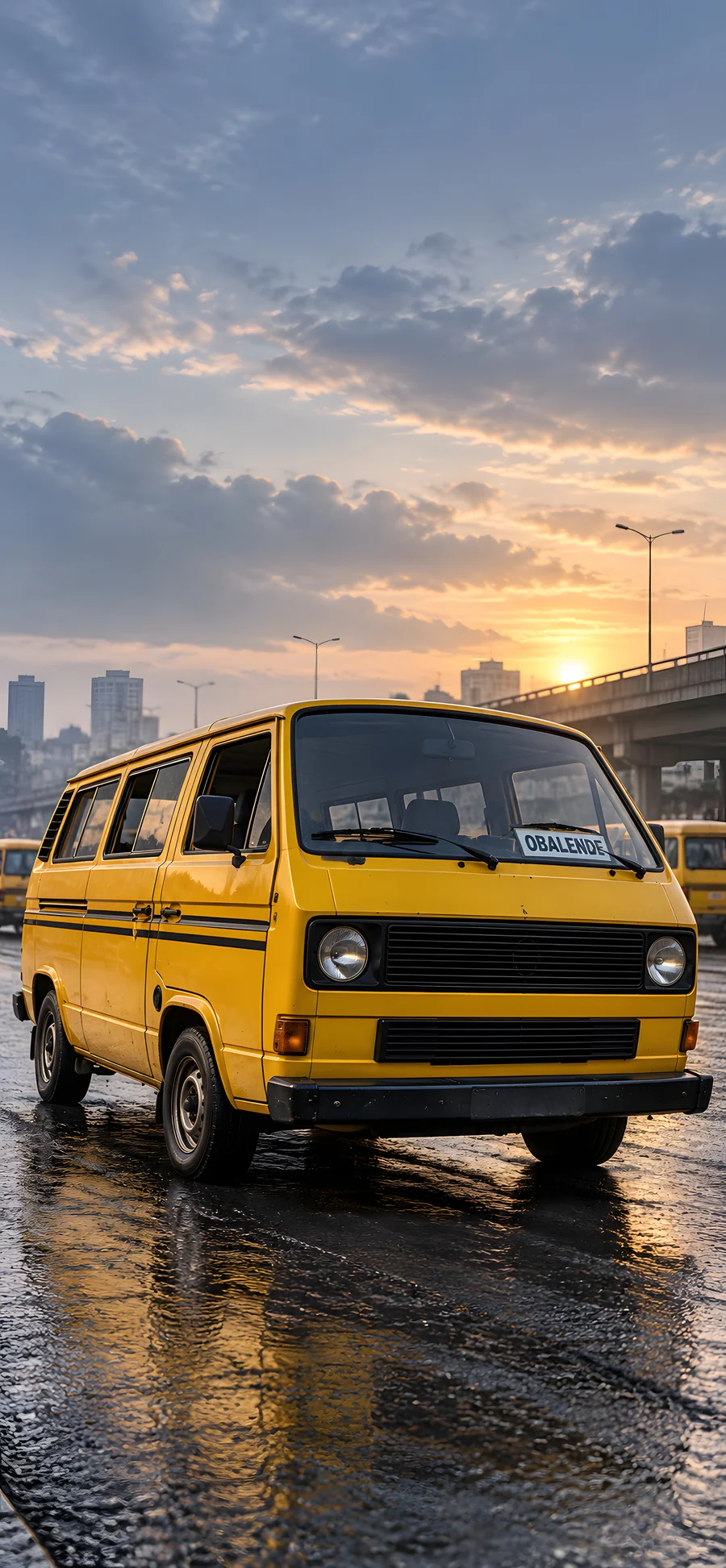 A yellow danfo at first light, with an Obalende destination card and reflections on the road.